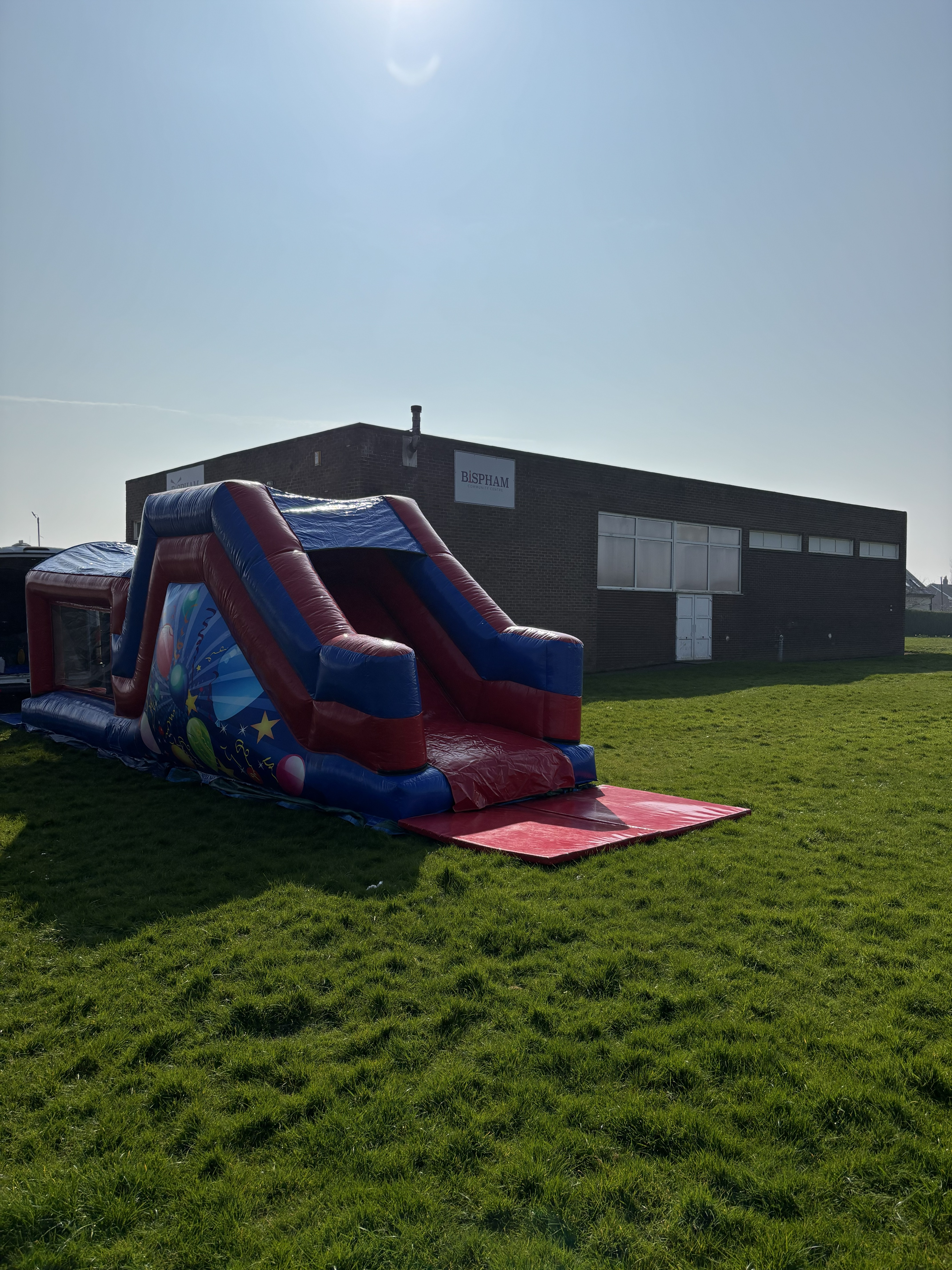 27ft inflatable assault course for hire outside Bispham Community Hall by Fylde Coast Bouncy Castles