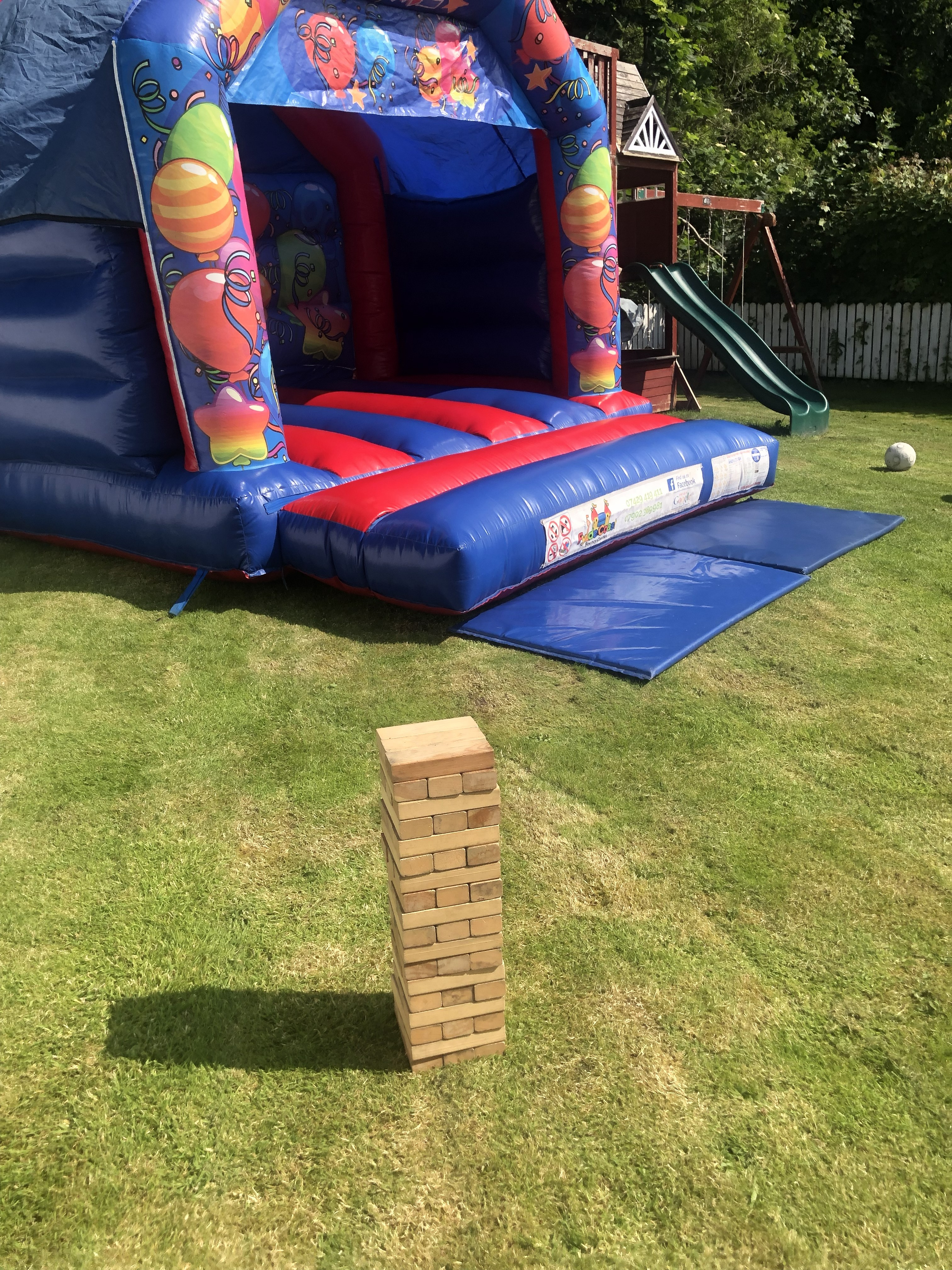 Large inflatable slide setup for a private garden party in Singleton by Fylde Coast Bouncy Castles.